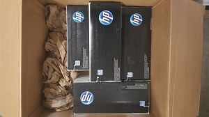 Toner cartridges packed snugly inside a box with paper padding, ready for overboxing